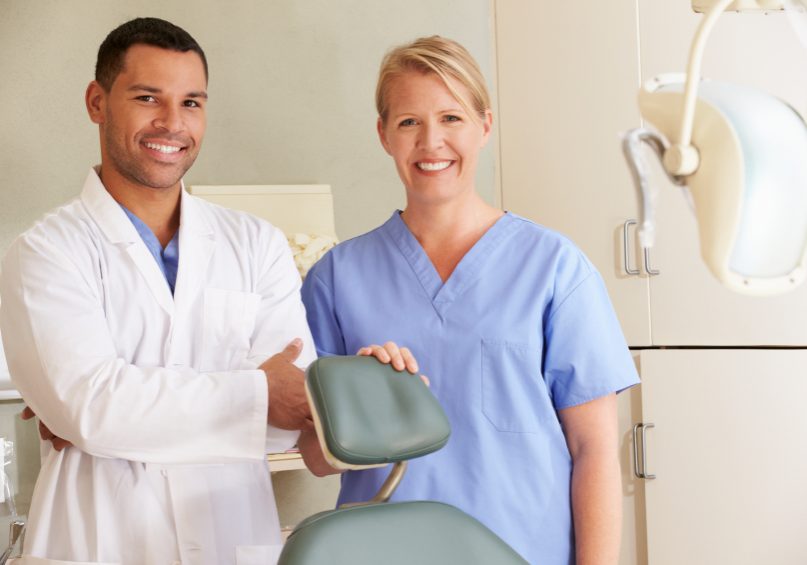 Portrait Of Dentist And Dental Nurse In Surgery