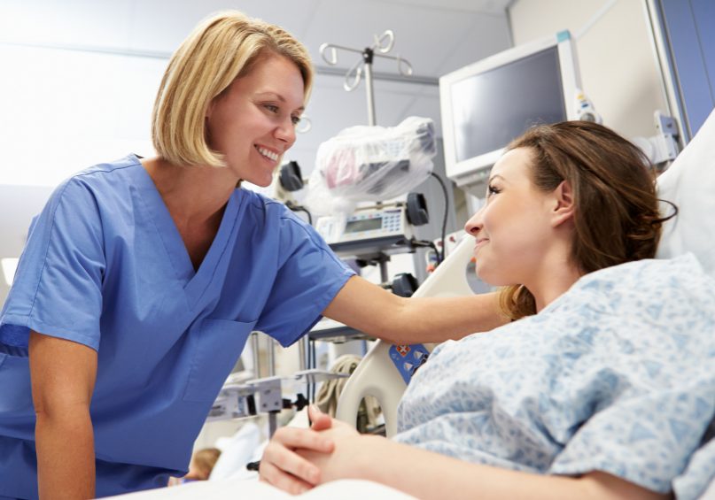 Young Female Patient Talking To Nurse In Emergency Room